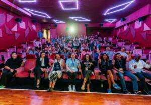 The CICAE students in a cinema auditorium. They look at the camera and smile