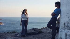 Still from ROMEIRA of a young woman and a young man standing at the edge of a cliff.