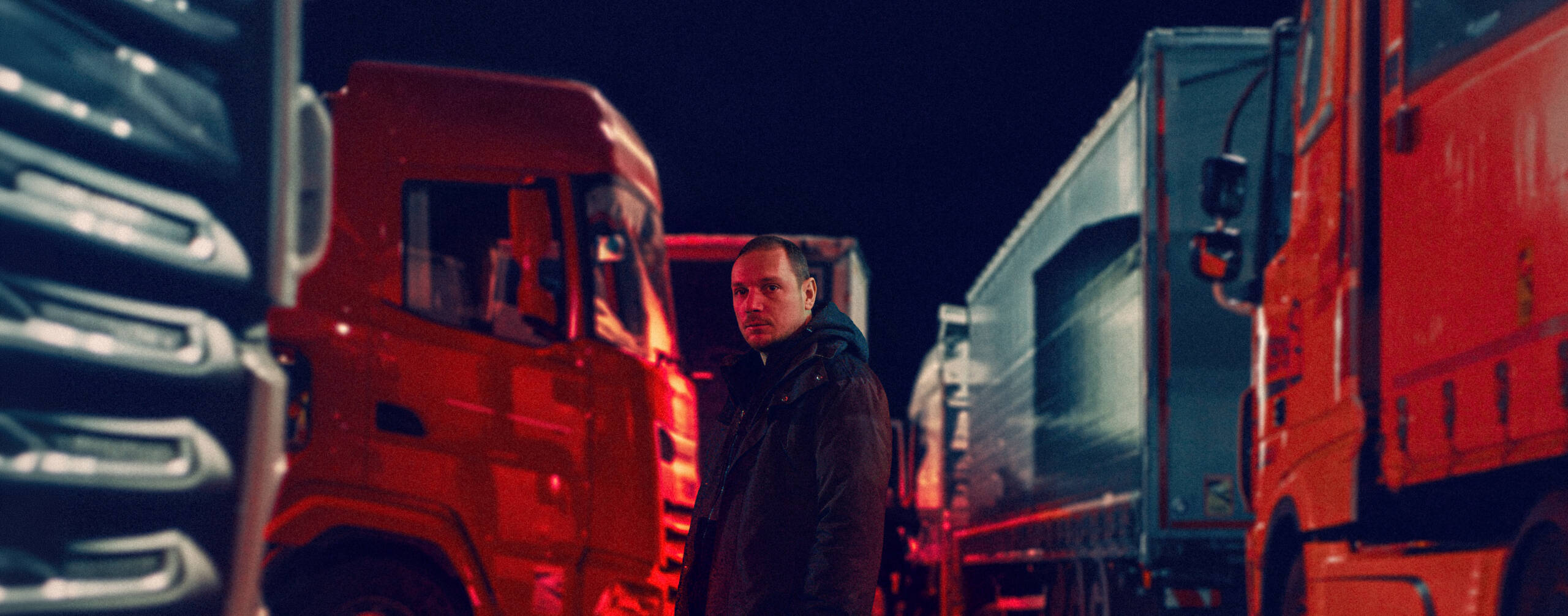 Cannes Ones to Watch: Flesh and Fuel

Still shows a person stood between trucks with a glowing red light